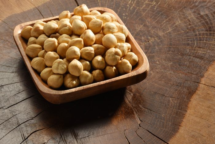 Hazelnuts,In,A,Wooden,Bowl,,On,The,Wood,Background