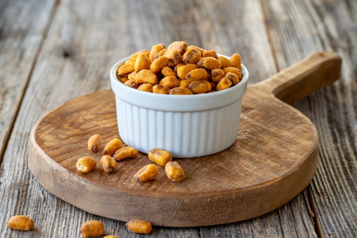 Roasted,Corn,Snack.,Corn,Nuts,With,Sauce,On,Wood,Background.